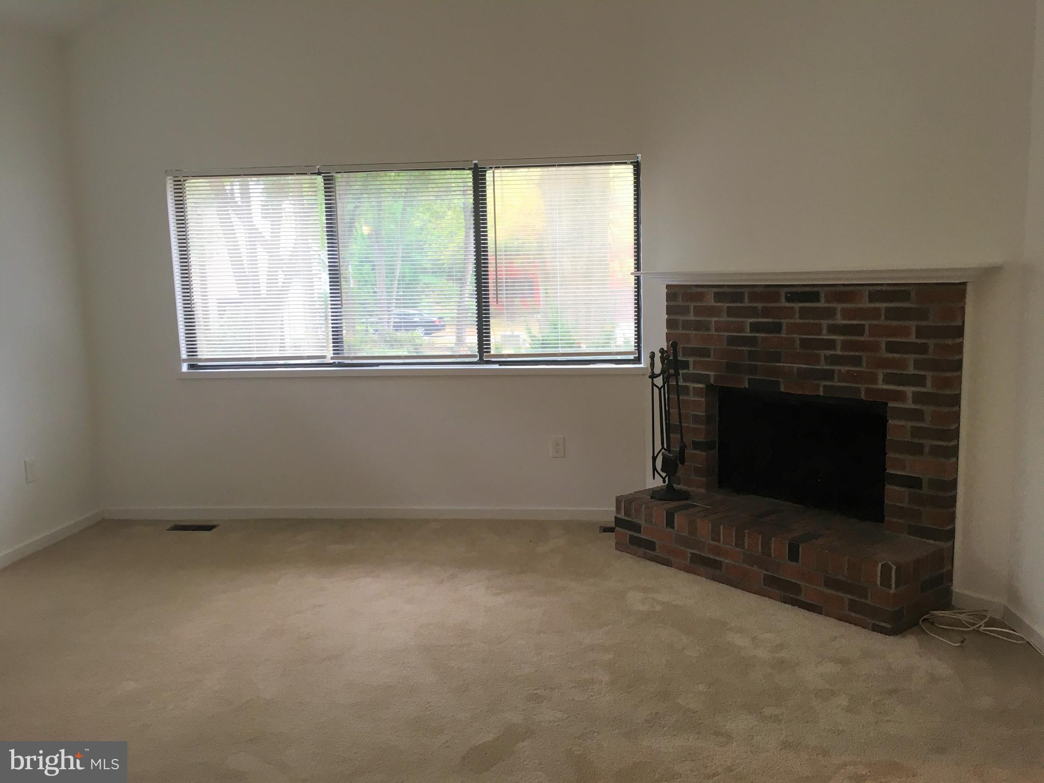10343 Tailcoat Way Columbia, MD 21044 - Photo 7 of 21 an empty room with a fireplace