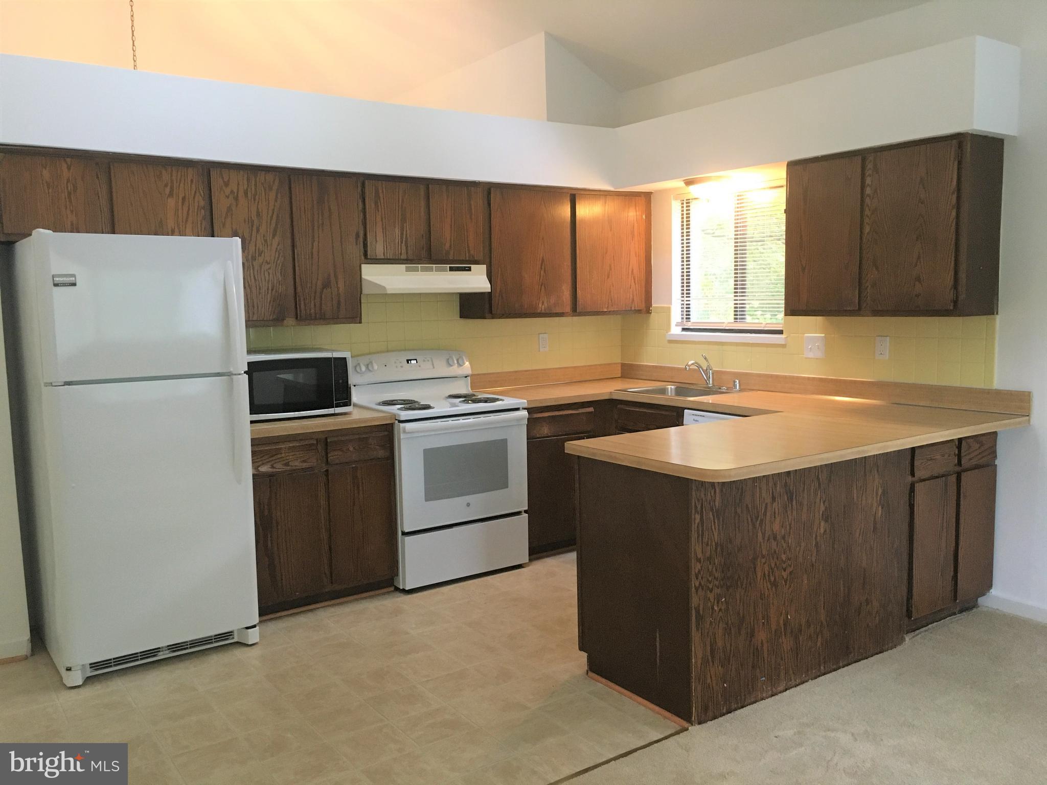 10343 Tailcoat Way Columbia, MD 21044 - Photo 8 of 21 a kitchen with a sink stove and refrigerator