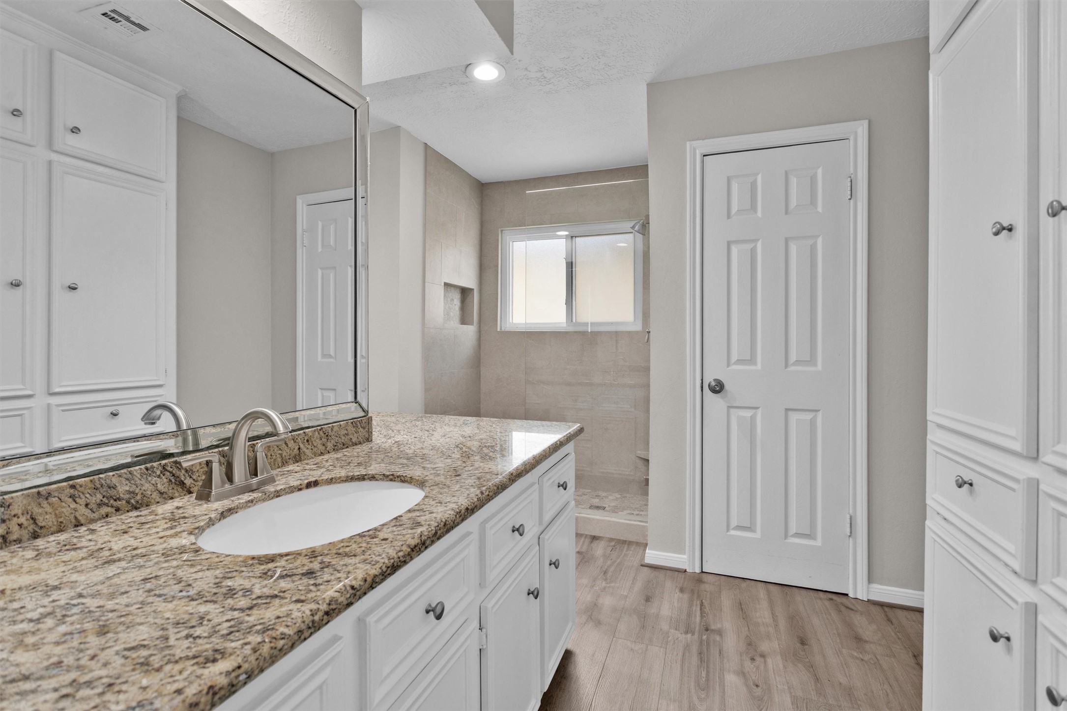9115 Godstone Lane Spring, TX 77379 - Photo 25 of 46 This modern bathroom boasts granite countertops and ample storage along with a recently renovated walk in shower.