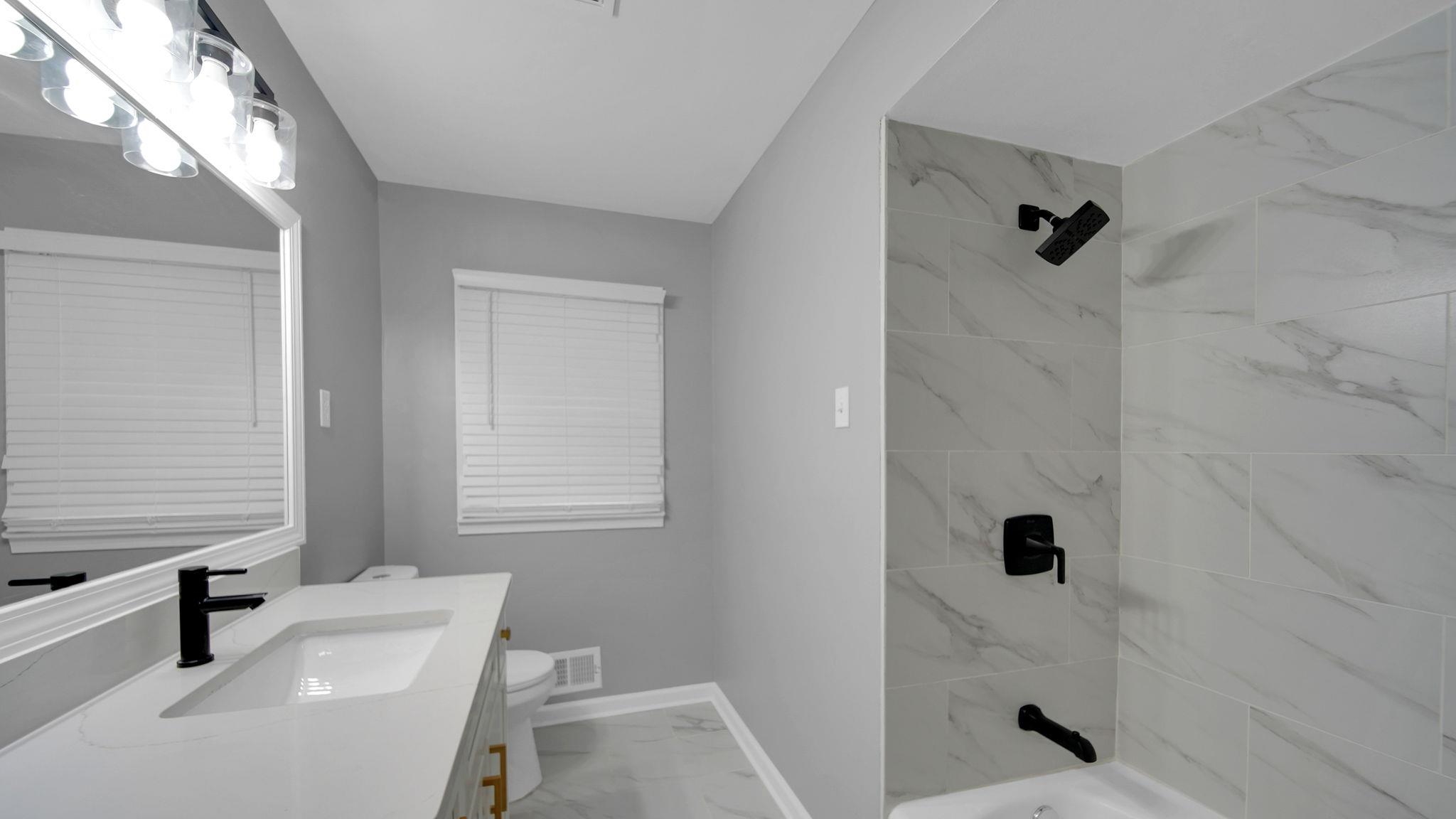 5256 Collingwood Road Memphis, TN 38117 - Photo 30 of 40 Full bath with light marble finish floors, shower / bathtub combination, and vanity