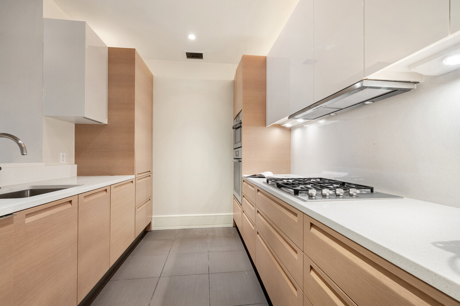 255 East 74th Street, Unit 6B Manhattan, NY 10021 - Photo 5 of 10 a kitchen with granite countertop a stove and a sink