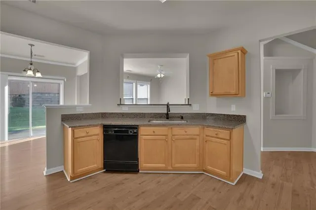 a kitchen with stainless steel appliances granite countertop a stove and cabinets