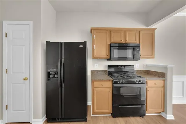 a kitchen with a refrigerator stove and microwave