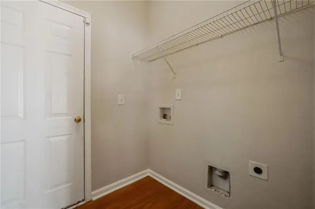 a view of a room with wooden floor