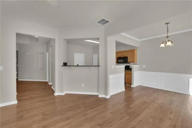 a view of a kitchen with a sink and a refrigerator