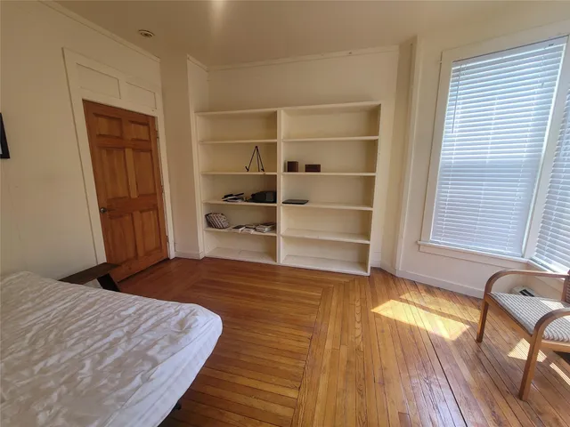 a bedroom with a bed and a chair