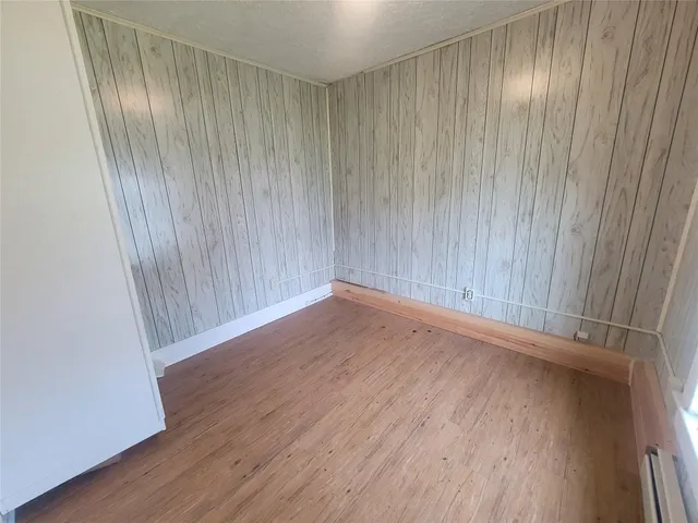 a view of a room with wooden floor