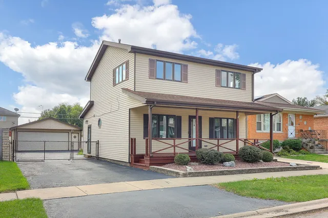 a front view of a house with a garden and plants