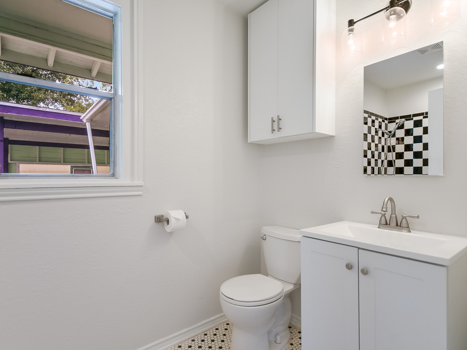 112 East Skyview Road Austin, TX 78752 - Photo 7 of 10 a bathroom with a sink toilet and mirror