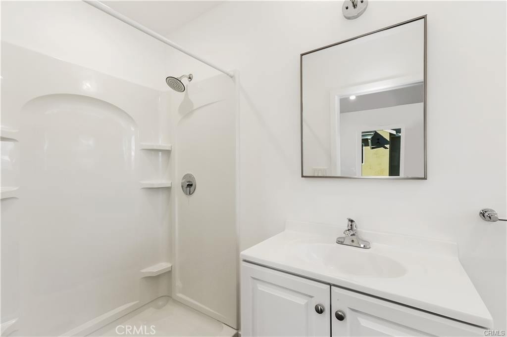 552 North Cambridge Street Orange, CA 92867 - Photo 11 of 18 a bathroom with a granite countertop sink a toilet and mirror