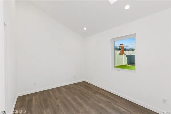 a room with a window and wooden floor