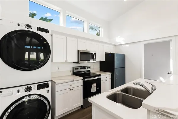 a kitchen with a washer and dryer