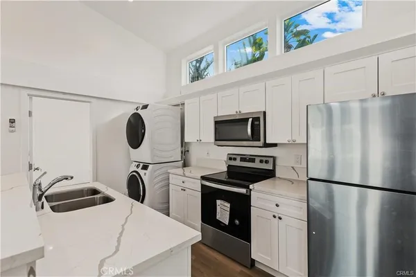 a kitchen with a refrigerator and a stove top oven
