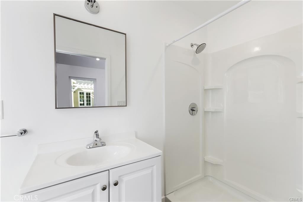 552 North Cambridge Street Orange, CA 92867 - Photo 10 of 18 a bathroom with a sink a mirror and shower