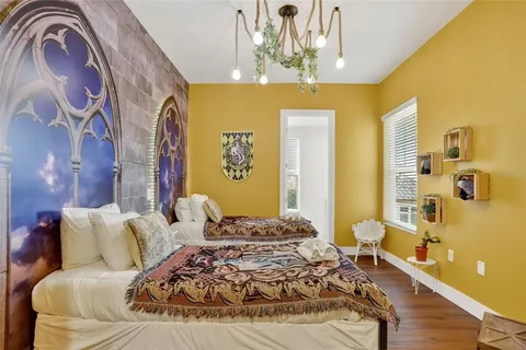 a bedroom with a bed and wooden floor