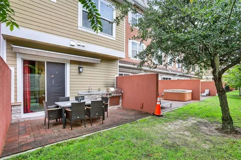 a view of a house with backyard and sitting area