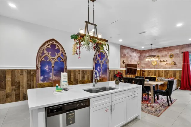 a kitchen with a sink a table and chairs