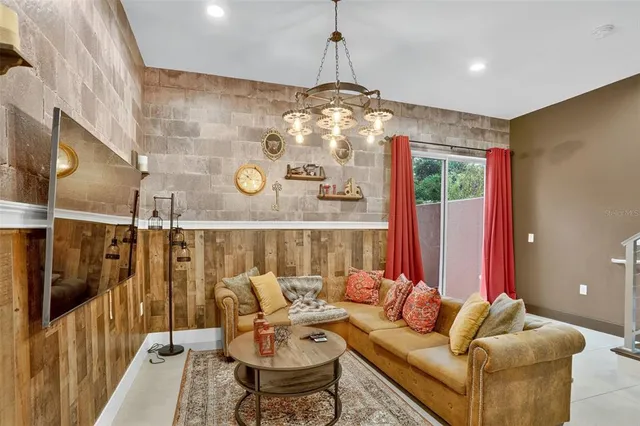 a living room with furniture and a chandelier