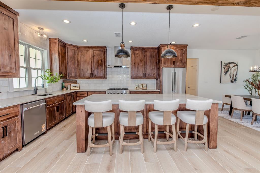 2847 Canyon Wren Loop Graford, TX 76449 - Photo 13 of 40 a large kitchen with a table and chairs