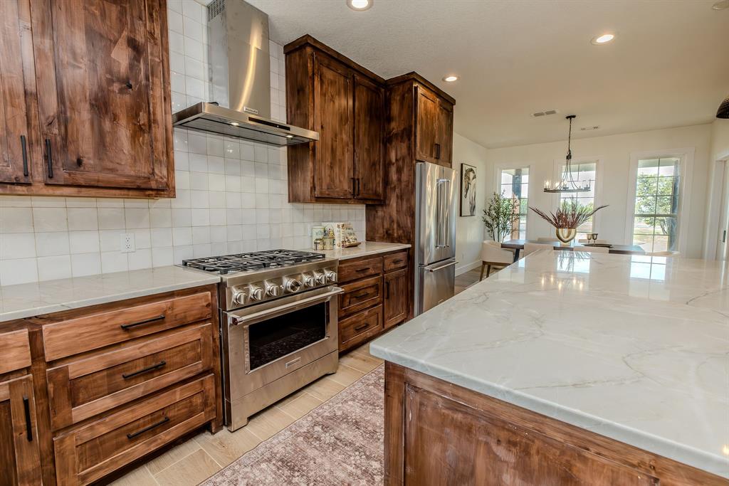 2847 Canyon Wren Loop Graford, TX 76449 - Photo 16 of 40 a kitchen with a stove and a refrigerator