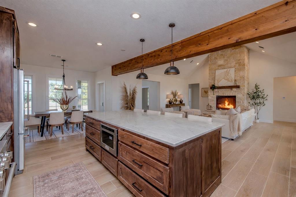 2847 Canyon Wren Loop Graford, TX 76449 - Photo 18 of 40 a large room with kitchen island a sink a counter space and stainless steel appliances