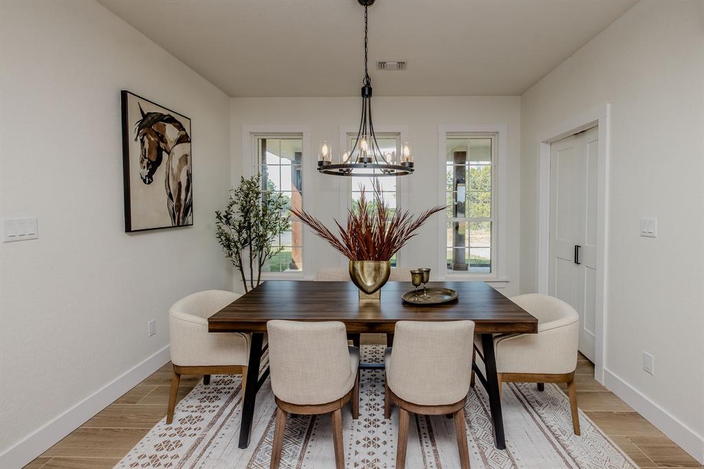 2847 Canyon Wren Loop Graford, TX 76449 - Photo 20 of 40 a view of a dining room with furniture and wooden floor