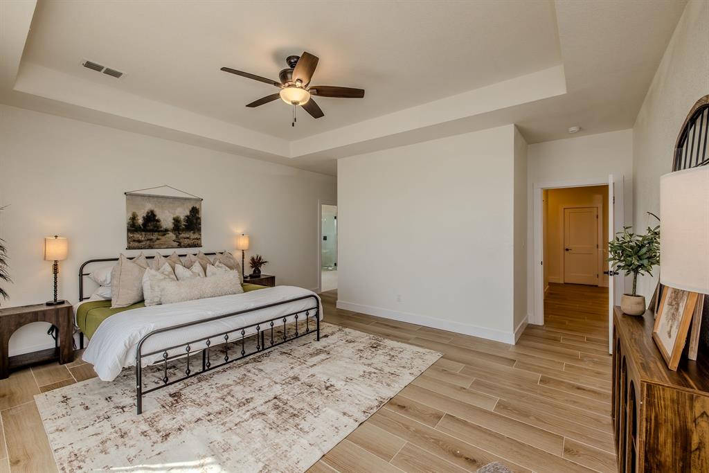 2847 Canyon Wren Loop Graford, TX 76449 - Photo 23 of 40 a bedroom with a bed and wooden floor