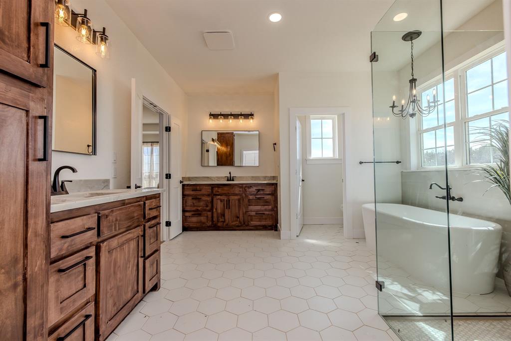 2847 Canyon Wren Loop Graford, TX 76449 - Photo 26 of 40 a spacious bathroom with a double vanity sink a mirror and a shower