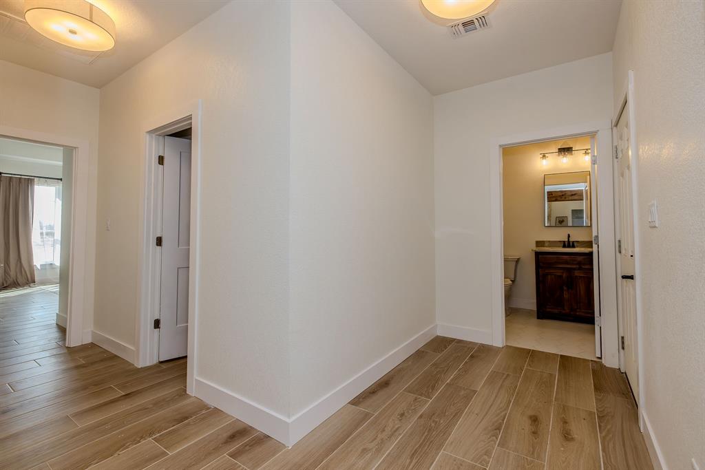 2847 Canyon Wren Loop Graford, TX 76449 - Photo 29 of 40 wooden floor in an empty room