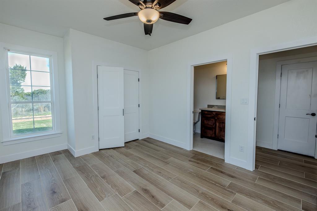 2847 Canyon Wren Loop Graford, TX 76449 - Photo 35 of 40 wooden floor in an empty room with a window
