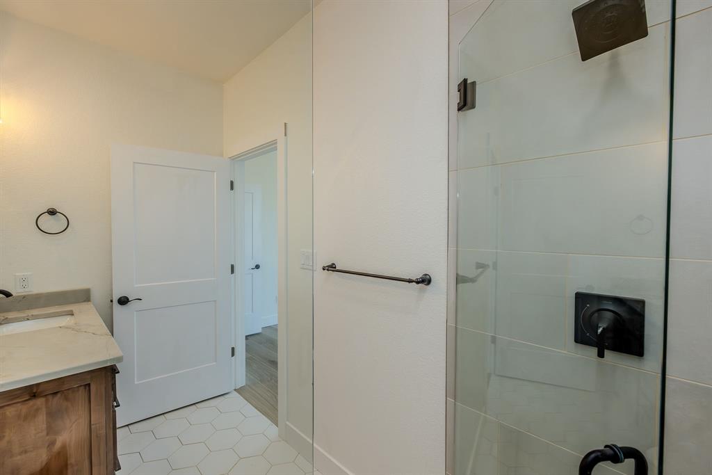 2847 Canyon Wren Loop Graford, TX 76449 - Photo 36 of 40 a bathroom with a granite countertop sink a toilet and shower