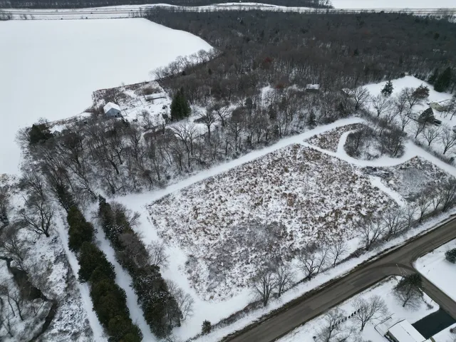 a view of a yard with wooden fence