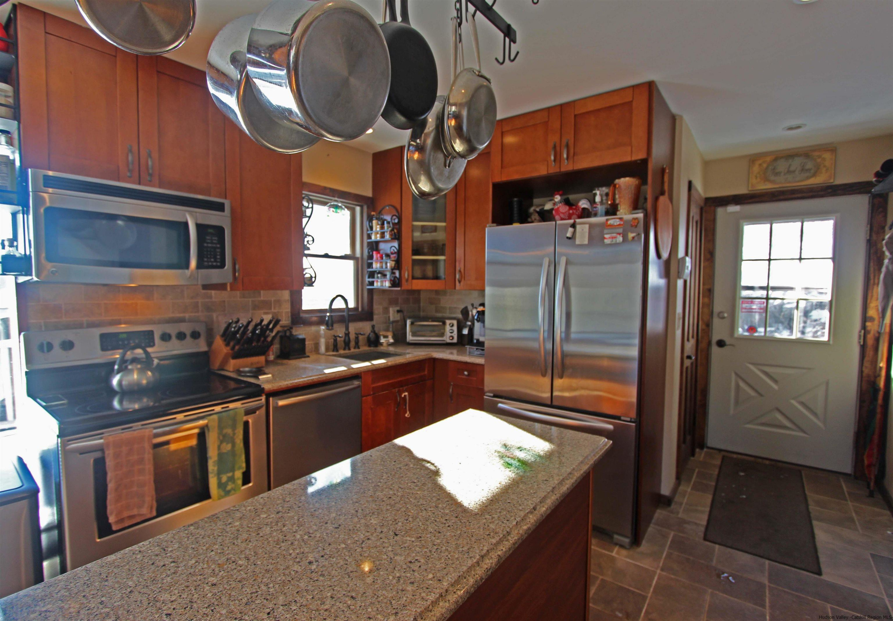 143 Rossman Road Roxbury, NY 12421 - Photo 14 of 35 a kitchen with stainless steel appliances granite countertop a sink a stove and a refrigerator