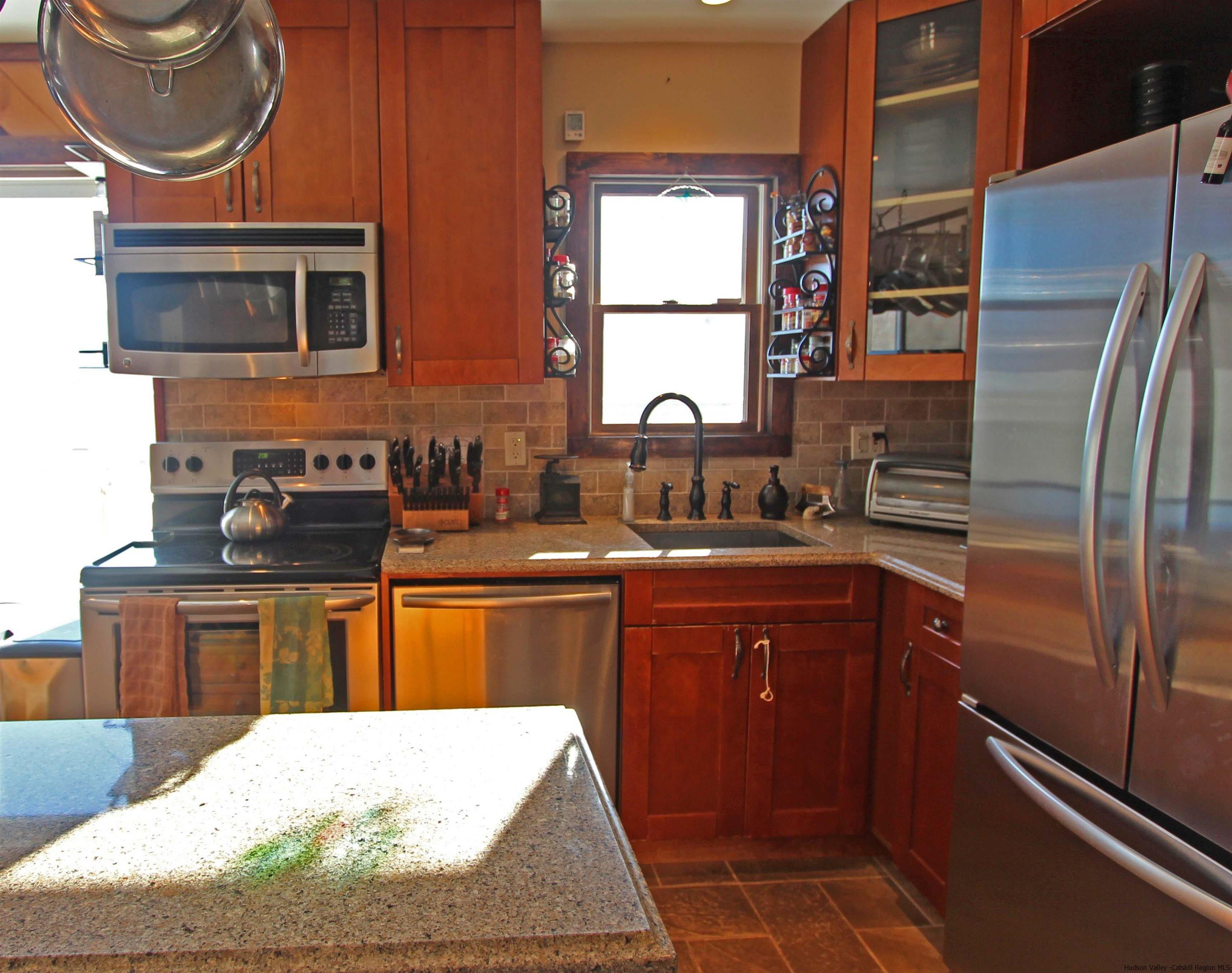 143 Rossman Road Roxbury, NY 12421 - Photo 15 of 35 a kitchen with stainless steel appliances granite countertop a sink stove and refrigerator