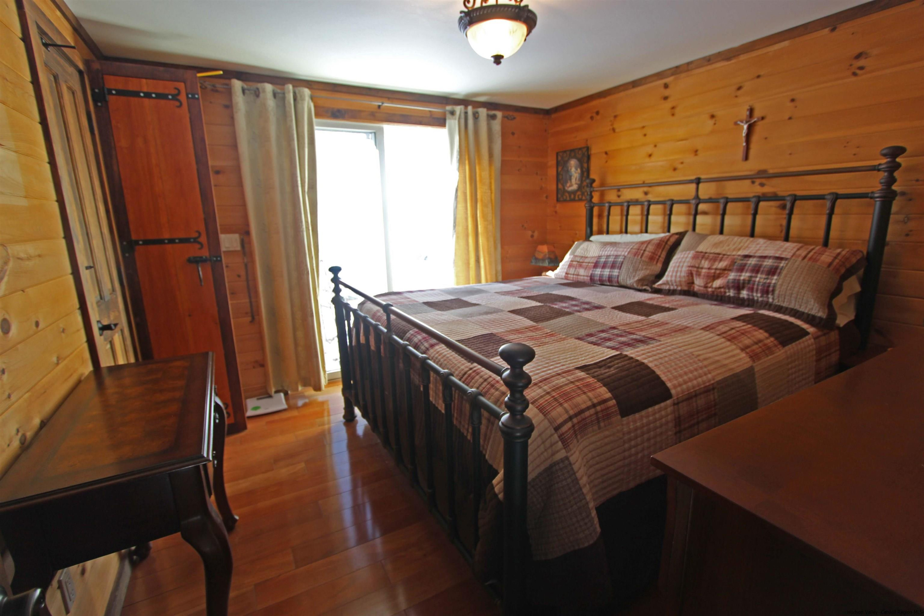 143 Rossman Road Roxbury, NY 12421 - Photo 27 of 35 a bed sitting in a bedroom next to a window