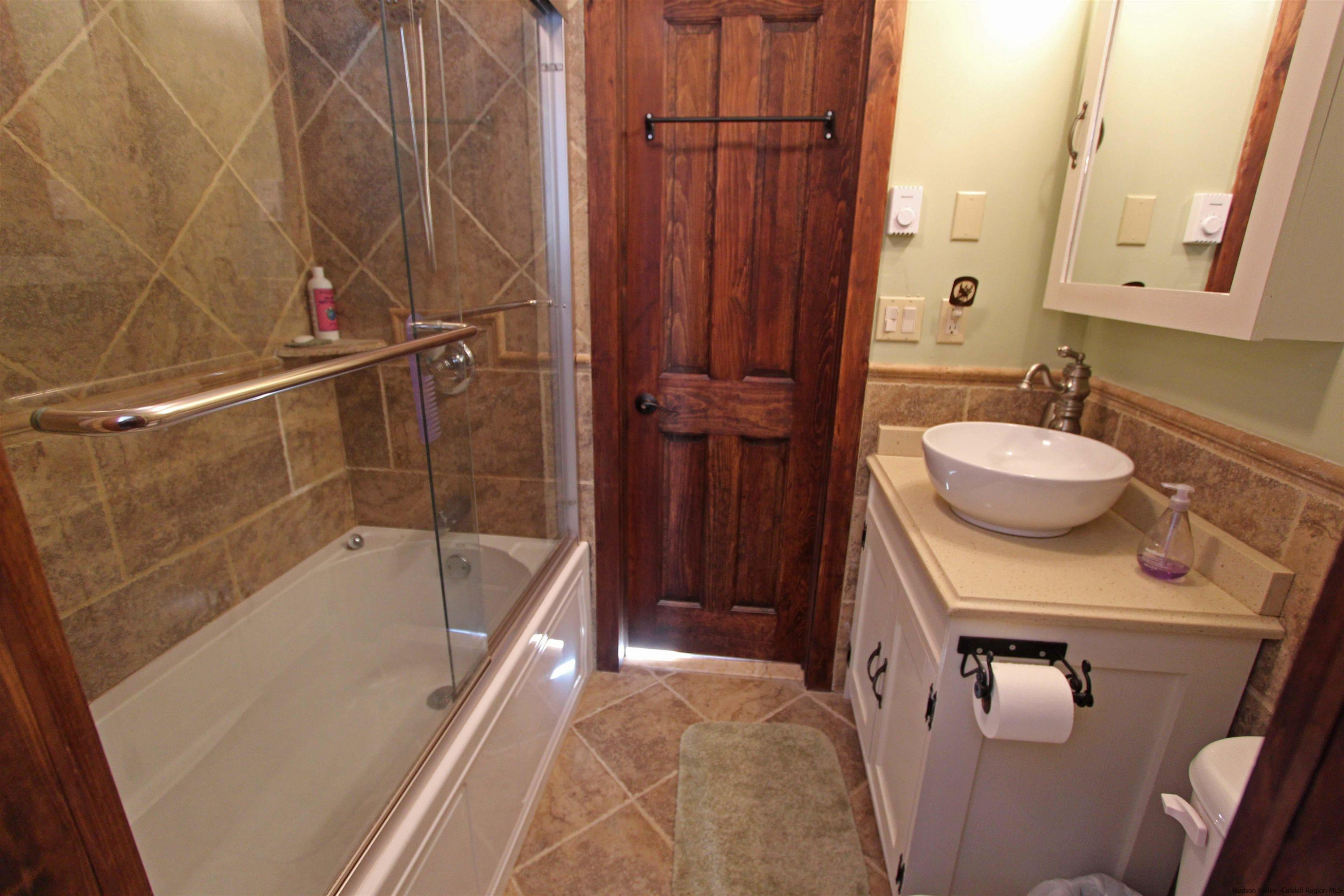 143 Rossman Road Roxbury, NY 12421 - Photo 30 of 35 a bathroom with a sink a toilet and bathtub