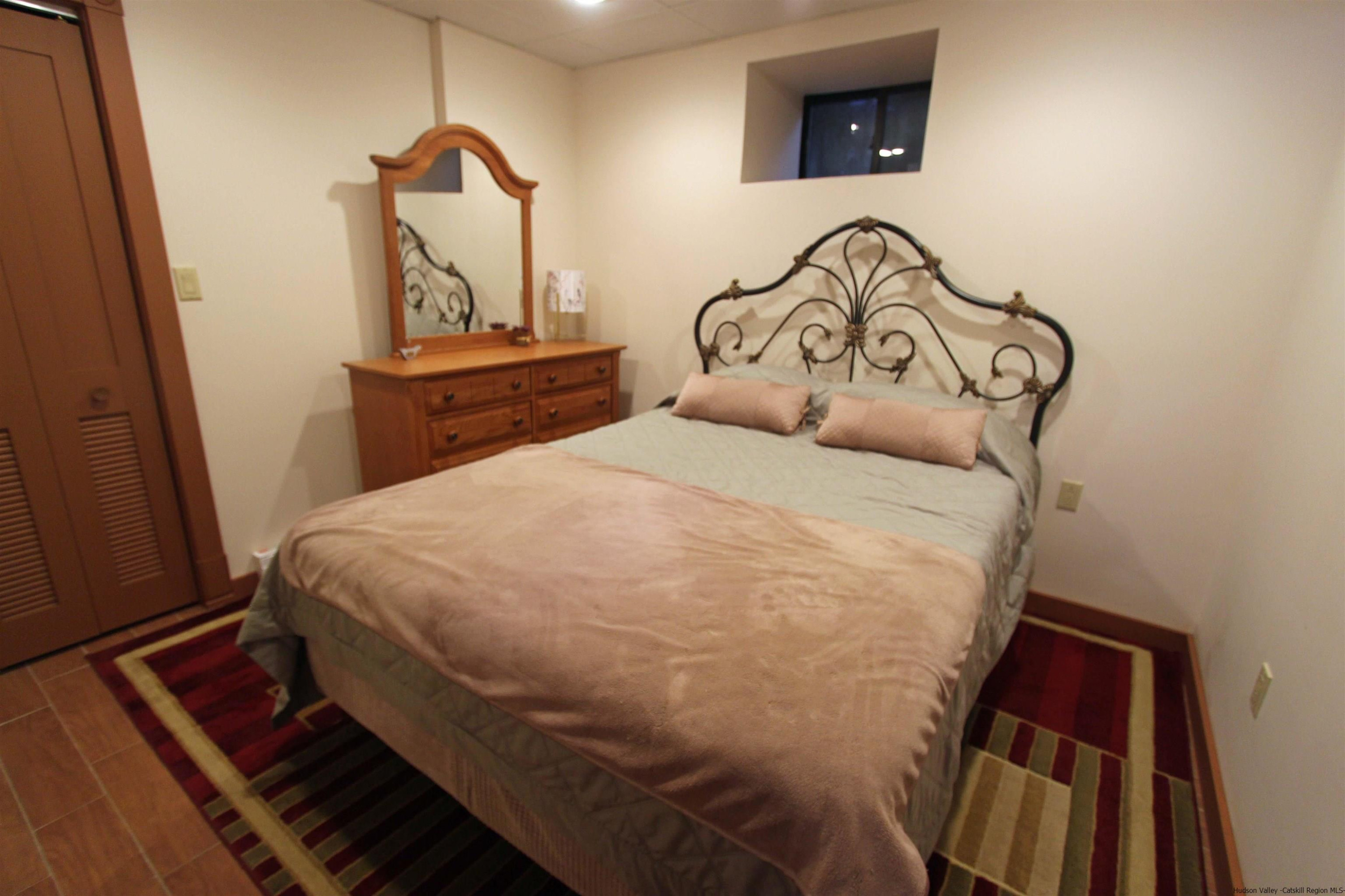 143 Rossman Road Roxbury, NY 12421 - Photo 34 of 35 a bedroom with a bed and a window