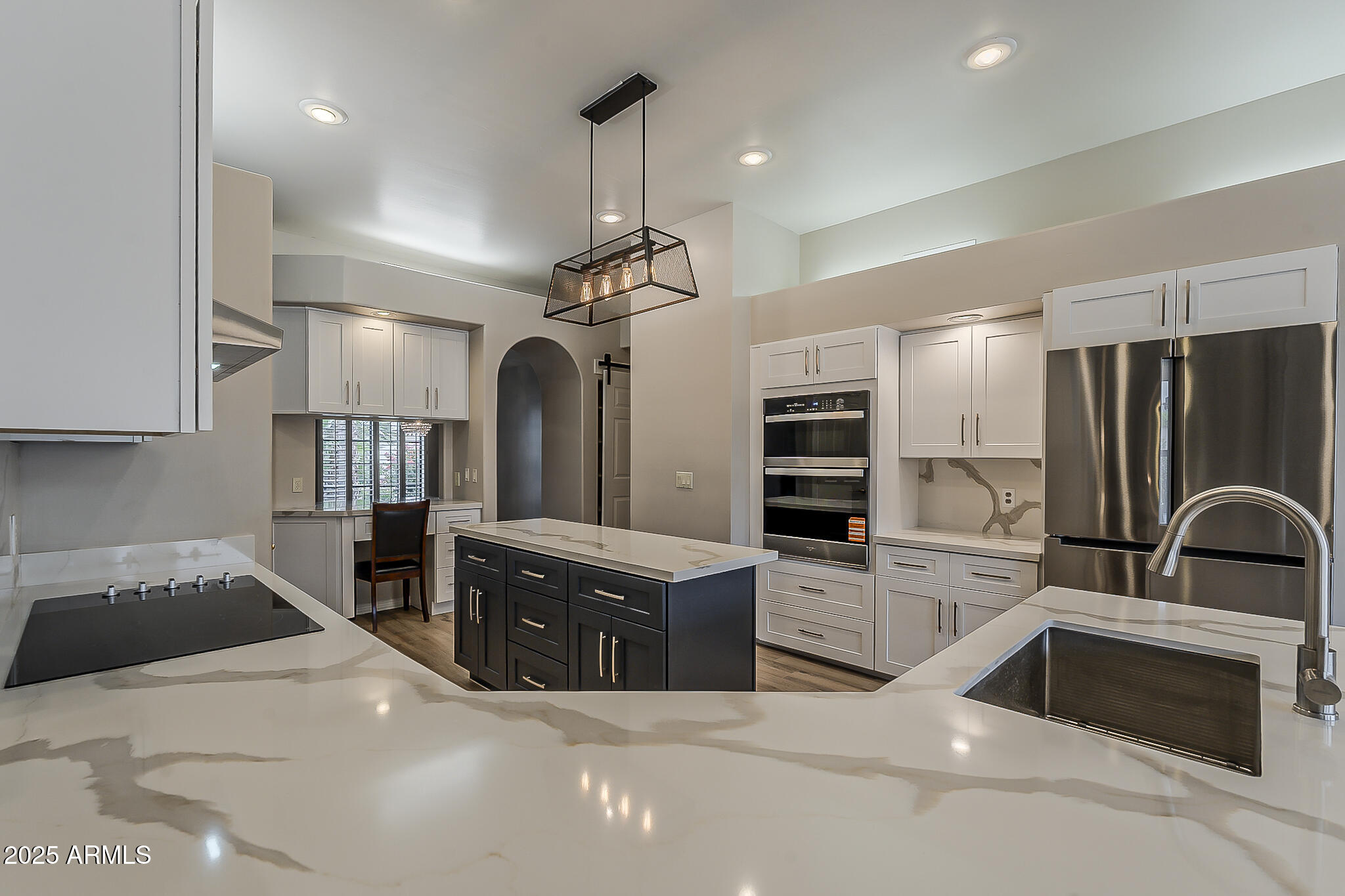5345 East McLellan Road, Unit 112 Mesa, AZ 85205 - Photo 26 of 74 a kitchen with stainless steel appliances kitchen island granite countertop a refrigerator and a stove top oven