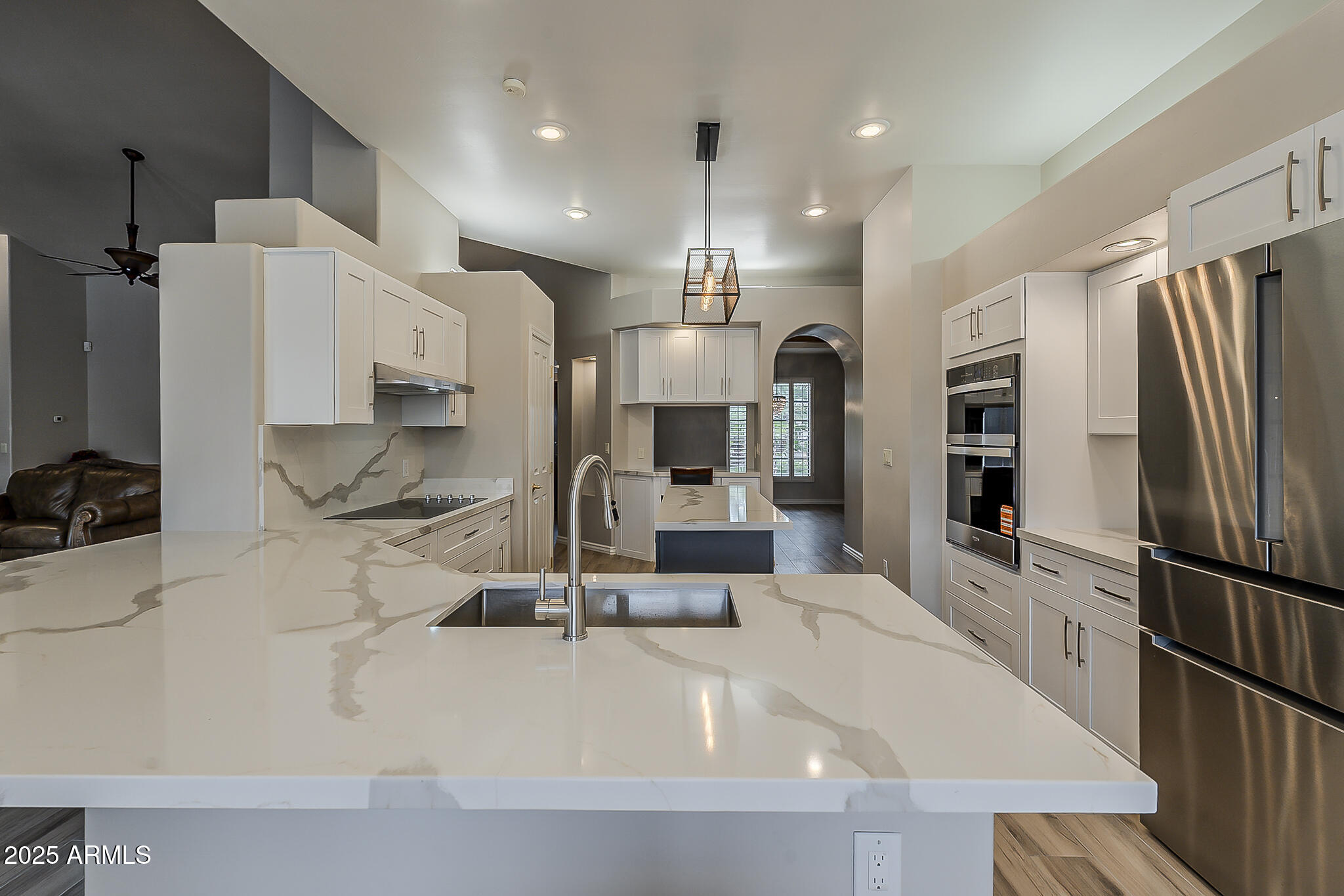 5345 East McLellan Road, Unit 112 Mesa, AZ 85205 - Photo 27 of 74 a kitchen with stainless steel appliances kitchen island granite countertop a refrigerator and a sink