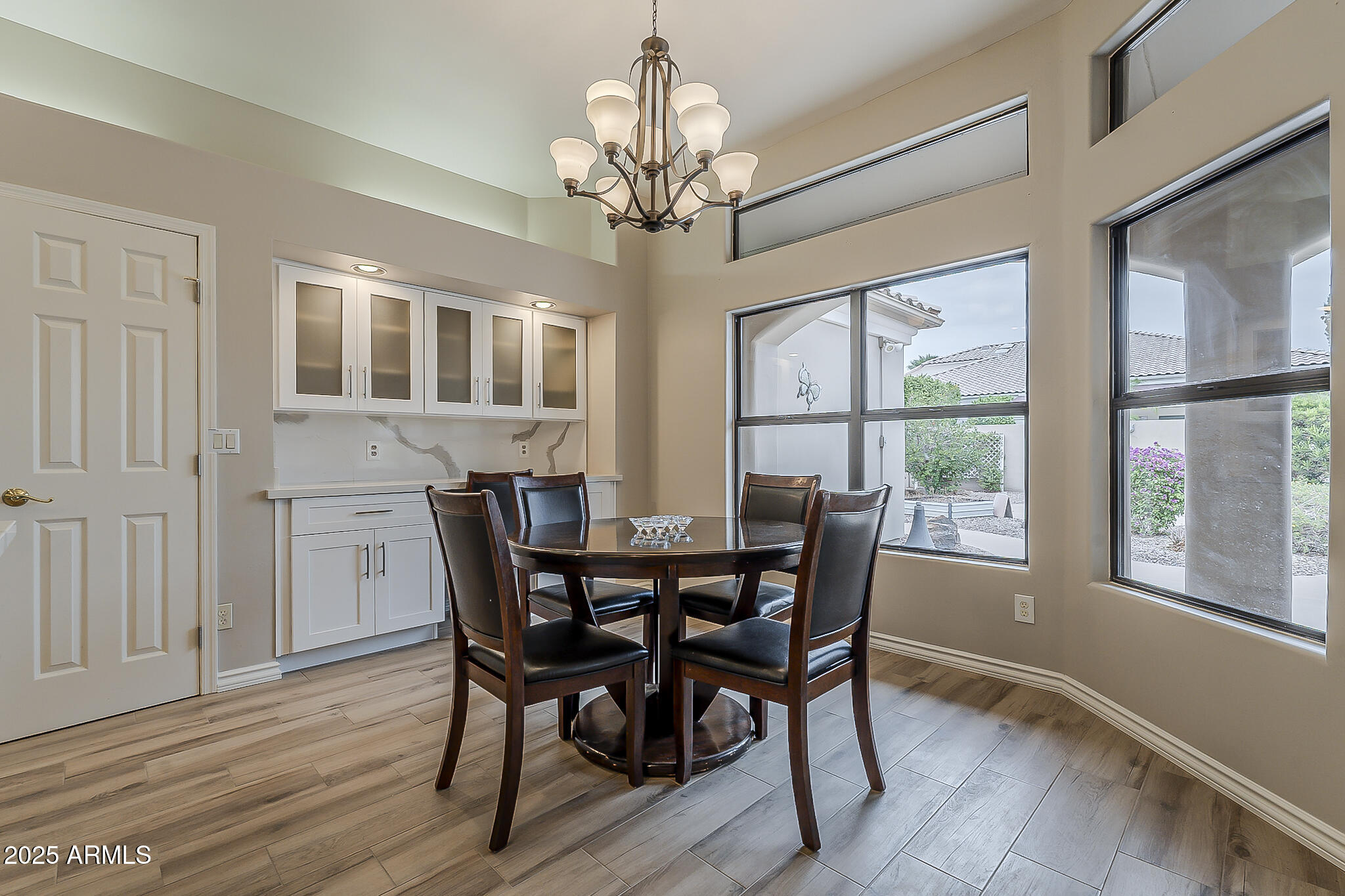 5345 East McLellan Road, Unit 112 Mesa, AZ 85205 - Photo 30 of 74 a view of a dining room with furniture a chandelier and wooden floor