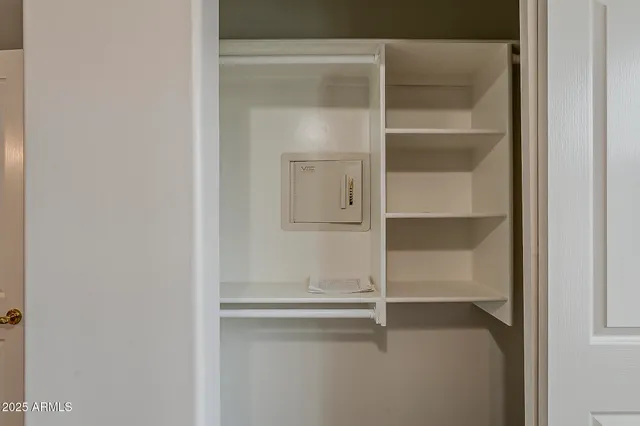 a view of an empty room and a ceiling fan