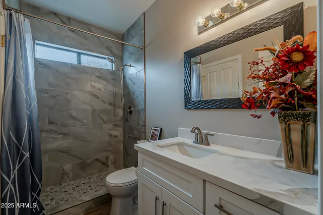 a view of a livingroom with a flat screen tv and windows