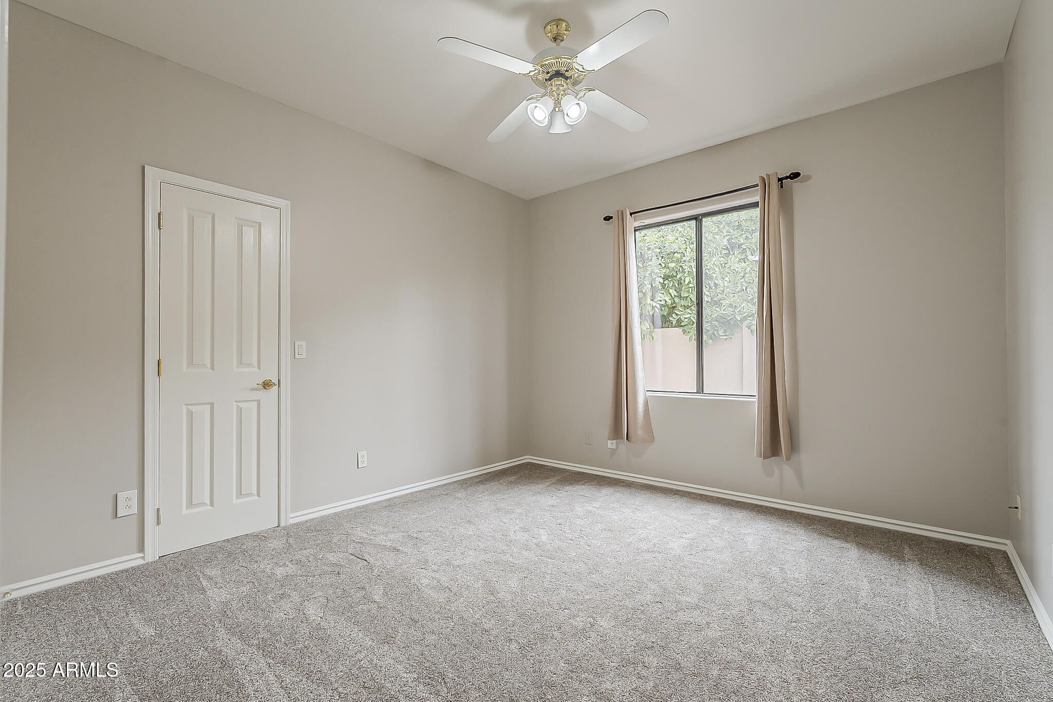 5345 East McLellan Road, Unit 112 Mesa, AZ 85205 - Photo 37 of 74 an empty room with windows and fan