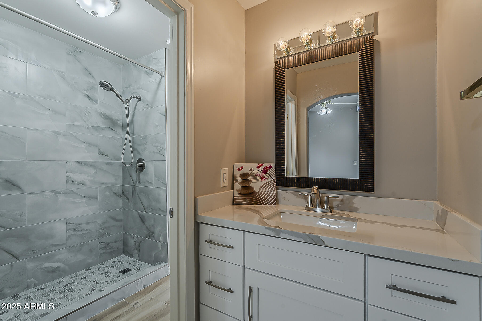 5345 East McLellan Road, Unit 112 Mesa, AZ 85205 - Photo 39 of 74 a bathroom with a shower sink and mirror