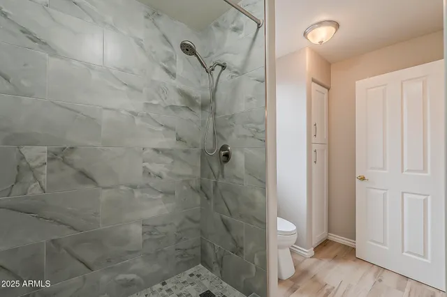 a spacious bathroom with a tub sink and mirror