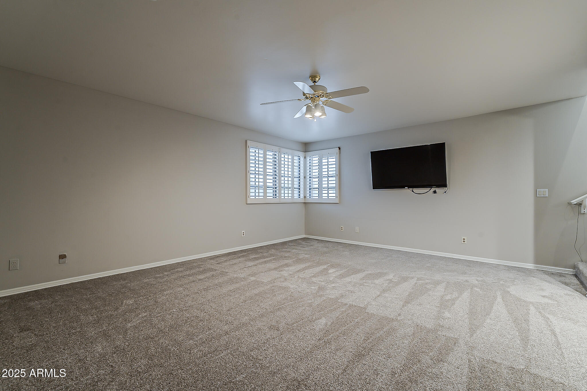 5345 East McLellan Road, Unit 112 Mesa, AZ 85205 - Photo 49 of 74 a view of a livingroom with a flat screen tv and windows