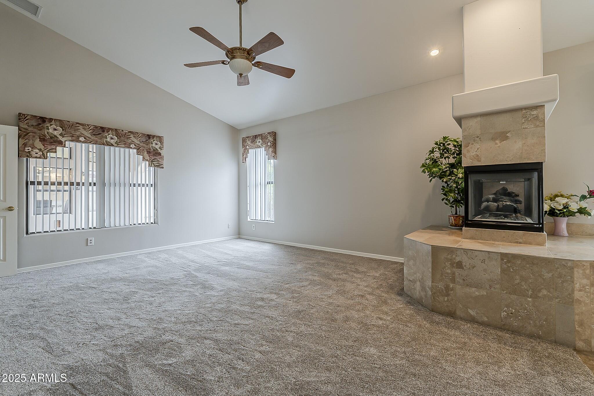 5345 East McLellan Road, Unit 112 Mesa, AZ 85205 - Photo 54 of 74 a view of an empty room with a fireplace and a window