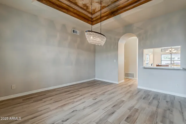 a view of a room with wooden floor and white walls