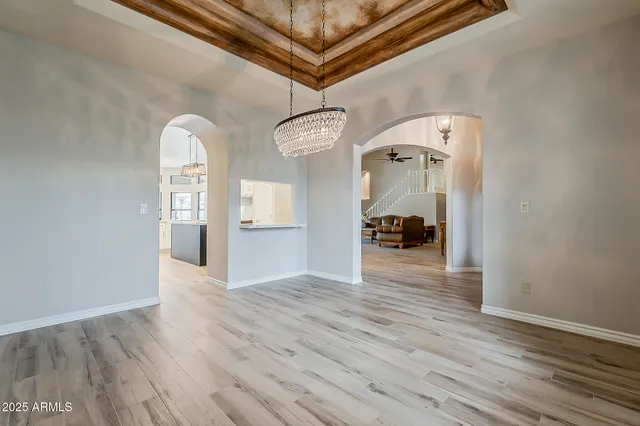 a view of a hallway with wooden floor and furniture