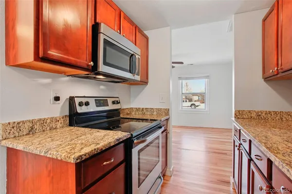 a kitchen with stainless steel appliances granite countertop a stove and a microwave